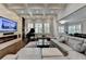 Stylish living room with a fireplace, piano, large windows, and comfortable seating arrangements at 7940 Royal Melbourne Way, Duluth, GA 30097