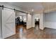 Elegant living area featuring hardwood floors, sliding barn doors, and access to an office and bedroom at 7940 Royal Melbourne Way, Duluth, GA 30097