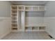 Well-organized mudroom features custom shelving, a bench, and storage for optimal convenience at 7940 Royal Melbourne Way, Duluth, GA 30097