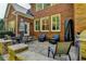 Outdoor patio with stone pavers, access to the backyard, a built-in grilling station and exterior brick finish at 7940 Royal Melbourne Way, Duluth, GA 30097