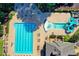 An aerial view of the community pool area, with clear water, a fountain, and a slide at 7940 Royal Melbourne Way, Duluth, GA 30097