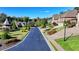 Quiet neighborhood street lined with beautiful homes, manicured lawns, and lush greenery at 7940 Royal Melbourne Way, Duluth, GA 30097