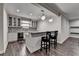 Basement wet bar with granite countertops, white cabinets, mosaic backsplash, and wine fridge at 7940 Royal Melbourne Way, Duluth, GA 30097