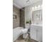 Modern bathroom with tiled shower over bath and white vanity at 10331 Wrens Dr, Jonesboro, GA 30238
