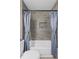 Stylish bathroom with a tiled shower, tub, and a built-in shelf at 10331 Wrens Dr, Jonesboro, GA 30238