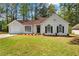 Charming single-story home features a well-manicured front yard and attached garage at 10331 Wrens Dr, Jonesboro, GA 30238