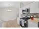 Contemporary kitchen with white cabinets, updated appliances, and modern lighting at 10331 Wrens Dr, Jonesboro, GA 30238