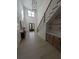 Grand foyer with high ceilings, staircase with iron railing, and stylish console table at 315 Hillcrest View Dr, Suwanee, GA 30024