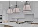 Island kitchen with pendant lights, stainless steel appliances, gas range and modern cabinetry at 315 Hillcrest View Dr, Suwanee, GA 30024