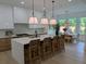 Open-concept kitchen with an island, bar seating, and a view of the dining area at 315 Hillcrest View Dr, Suwanee, GA 30024