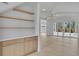 Open living room with built-in shelving, light wood floors, and sliding glass doors to the backyard at 315 Hillcrest View Dr, Suwanee, GA 30024