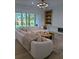 Bright living room featuring a comfortable sofa, fireplace, custom built-ins, and modern lighting fixture at 315 Hillcrest View Dr, Suwanee, GA 30024