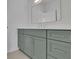 Bathroom featuring light green cabinets, white countertops, and modern fixtures at 315 Hillcrest View Drive, Suwanee, GA 30024