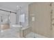 Contemporary bathroom with a standalone tub, a walk-in shower, and a sliding barn door at 315 Hillcrest View Drive, Suwanee, GA 30024