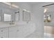 Bright, spacious bathroom with dual sinks, modern light fixtures, and a view of an adjacent room at 315 Hillcrest View Drive, Suwanee, GA 30024