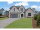 Charming two-story home featuring a brick facade, well-manicured lawn, and a two-car garage, with a beautifully landscaped front yard at 315 Hillcrest View Drive, Suwanee, GA 30024