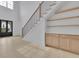 Elegant entry with a staircase, black framed front doors, built in cabinets, hardwood floors, and high ceilings at 315 Hillcrest View Drive, Suwanee, GA 30024
