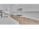Close up of kitchen showcasing a center island, stainless steel appliances, and white quartz countertops and backsplash at 315 Hillcrest View Drive, Suwanee, GA 30024
