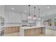 Bright kitchen with a large island, marble countertops, stainless steel appliances, and sleek, modern cabinetry at 315 Hillcrest View Drive, Suwanee, GA 30024