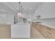 Spacious kitchen with a large center island, quartz countertops, stainless steel appliances, and custom cabinetry at 315 Hillcrest View Drive, Suwanee, GA 30024
