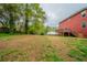A expansive backyard boasts mature trees, lush grass, and leads up to a deck at 4915 Wycliffe Dr, Stone Mountain, GA 30087