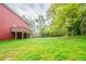 Spacious backyard with lush lawn, wooden deck, and mature trees providing shade and privacy at 4915 Wycliffe Dr, Stone Mountain, GA 30087