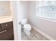 Bathroom showcasing a toilet and vanity with natural light from the window at 4915 Wycliffe Dr, Stone Mountain, GA 30087