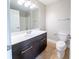 The bathroom showcases a single sink vanity with dark wood cabinets and a large mirror at 4915 Wycliffe Dr, Stone Mountain, GA 30087