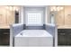Bathroom showcasing a large soaking tub with tiled surround and double vanities at 4915 Wycliffe Dr, Stone Mountain, GA 30087