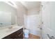 A bathroom with a shower-tub combo, a dark brown vanity, and ceramic tile flooring at 4915 Wycliffe Dr, Stone Mountain, GA 30087