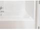 A close-up shows the clean lines of a bright white, modern bathtub at 4915 Wycliffe Dr, Stone Mountain, GA 30087