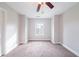 Bright bedroom featuring a ceiling fan and a window providing plenty of natural light at 4915 Wycliffe Dr, Stone Mountain, GA 30087