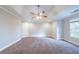 Large bedroom featuring neutral walls, crown molding, and a ceiling fan with lighting at 4915 Wycliffe Dr, Stone Mountain, GA 30087