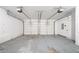 A large, two-car garage with white walls and two automatic garage doors at 4915 Wycliffe Dr, Stone Mountain, GA 30087