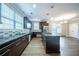 Modern kitchen featuring granite countertops, dark cabinets, and stainless steel appliances, offering a great cooking space at 4915 Wycliffe Dr, Stone Mountain, GA 30087