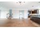 Open-concept living room with hardwood floors, a staircase, and a view into the modern kitchen at 4915 Wycliffe Dr, Stone Mountain, GA 30087