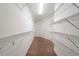Spacious walk-in closet featuring extensive shelving for storage and organization at 4915 Wycliffe Dr, Stone Mountain, GA 30087