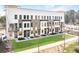 Modern townhome with manicured lawn, featuring a brick facade and contemporary black-framed windows at 7210 Summit Pl, Alpharetta, GA 30009