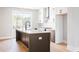 Contemporary kitchen with island, two-tone cabinets, quartz countertops, and stainless steel appliances at 7210 Summit Pl, Alpharetta, GA 30009