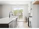 Kitchen featuring a large island, stainless steel appliances, and outdoor views at 7210 Summit Pl, Alpharetta, GA 30009