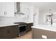 Modern kitchen featuring stainless steel appliances, white cabinets, and sleek countertops at 7210 Summit Pl, Alpharetta, GA 30009