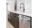 The kitchen features stainless steel appliances, and modern fixtures at 7210 Summit Pl, Alpharetta, GA 30009