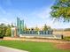A scenic view of Northwinds Summit community signage with lush green grass and a contemporary brick building at 7210 Summit Pl, Alpharetta, GA 30009