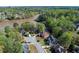 Aerial view of a community showcasing beautiful homes surrounded by lush greenery, mature trees, and a serene lake at 1450 Chadberry Way, Lawrenceville, GA 30043