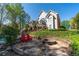 Beautiful backyard with a stone patio, fire pit, Adirondack chairs and mature trees, perfect for relaxing at 1450 Chadberry Way, Lawrenceville, GA 30043