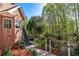 Beautiful backyard featuring an access staircase, well-manicured landscaping, and a glimpse of a pool at 1450 Chadberry Way, Lawrenceville, GA 30043