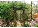 Enchanting backyard garden featuring a vine-covered pergola, creating a serene and picturesque outdoor space at 1450 Chadberry Way, Lawrenceville, GA 30043