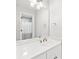 Bright bathroom with white vanity, gold fixtures, and an oversized mirror at 1450 Chadberry Way, Lawrenceville, GA 30043