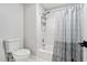 Bathroom with a standard toilet, shower head, and shower curtain at 1450 Chadberry Way, Lawrenceville, GA 30043