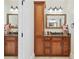 Bathroom with granite countertops, wood cabinetry, and dual mirrors providing ample space and storage at 1450 Chadberry Way, Lawrenceville, GA 30043